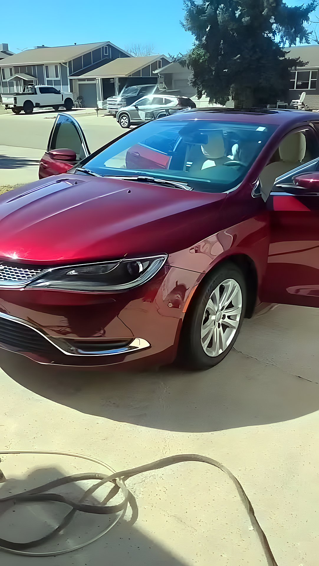 Red Chrysler detailed in a Denver driveway