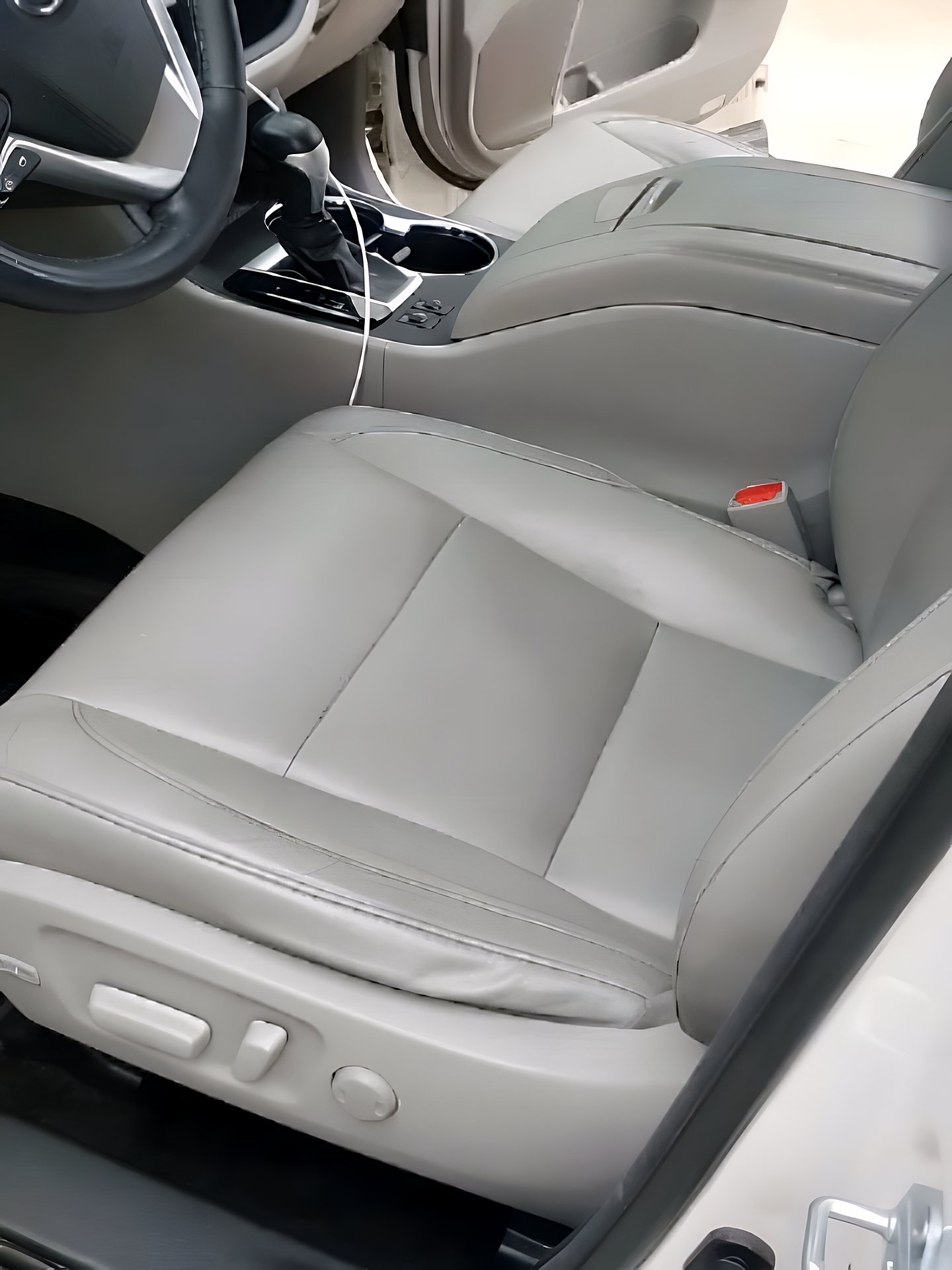 Clean leather front seats and center console after a deep interior detail